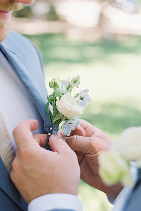  light blue and pink wedding with the groom in a light blue suit and the bride in a lace gown – groom close up