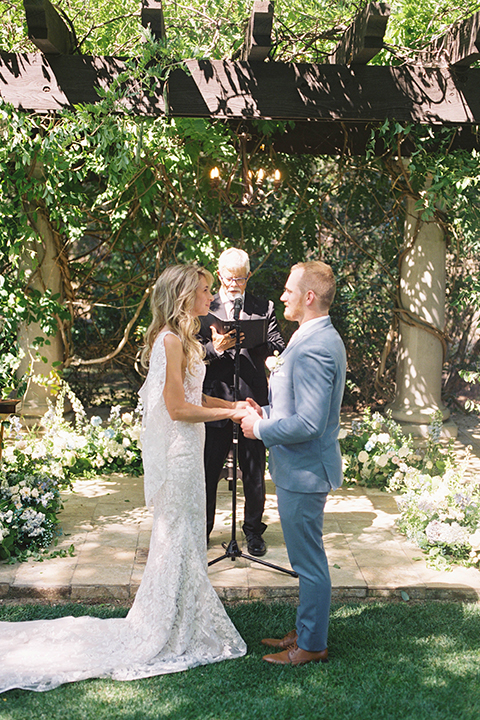  light blue and pink wedding with the groom in a light blue suit and the bride in a lace gown – ceremony 