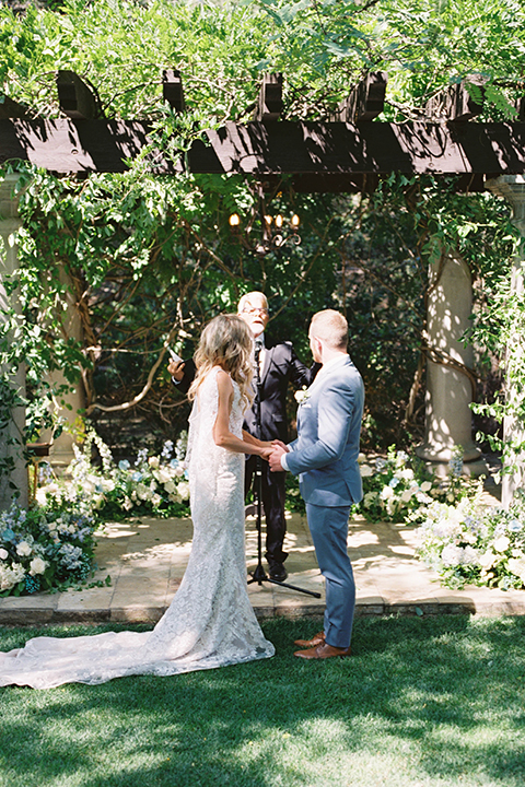  light blue and pink wedding with the groom in a light blue suit and the bride in a lace gown – ceremony 