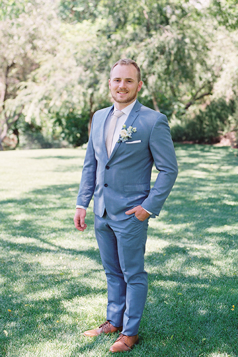  light blue and pink wedding with the groom in a light blue suit and the bride in a lace gown – groom close up 