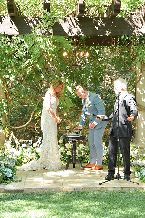  light blue and pink wedding with the groom in a light blue suit and the bride in a lace gown – ceremony 