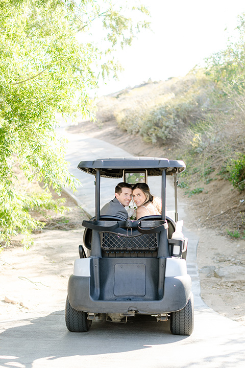  grey and dusty blue wedding with beachy touches - couple in the golf cart 