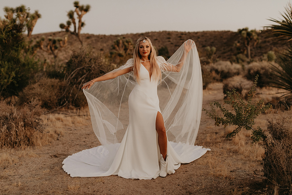  joshua tree wedding with the groom in a gold velvet tuxedo and a black tuxedo and the bride in a flowing gown with bridal wings – bride 