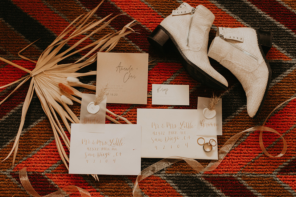  joshua tree wedding with the groom in a gold velvet tuxedo and a black tuxedo and the bride in a flowing gown with bridal wings – invitations