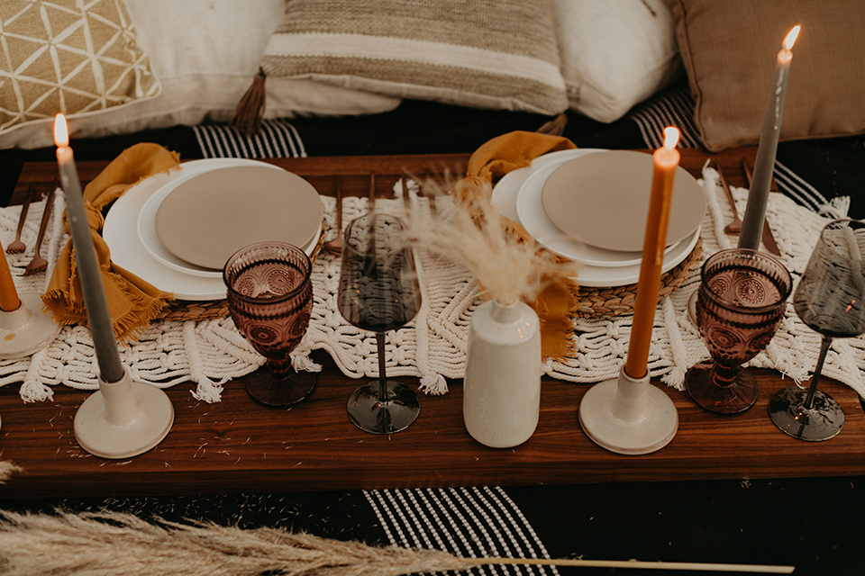  joshua tree wedding with the groom in a gold velvet tuxedo and a black tuxedo and the bride in a flowing gown with bridal wings – reception decor