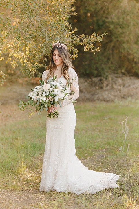 fairytale wedding in the meadow with the bride in a lace long sleeve gown and the groom in a slate blue and café brown look - bride 