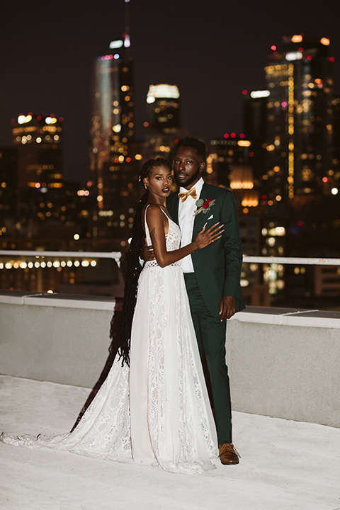  a chic LA studio shoot for a modern boho wedding – with the groom in a white lace gown and the groom in a green suit - bride 