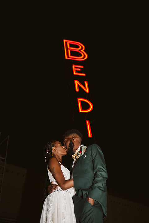  a chic LA studio shoot for a modern boho wedding – with the groom in a white lace gown and the groom in a green suit - bride