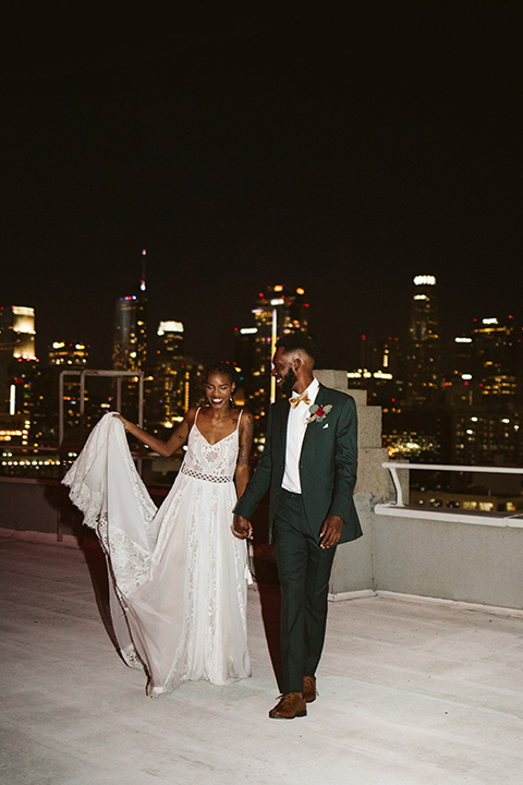  a chic LA studio shoot for a modern boho wedding – with the groom in a white lace gown and the groom in a green suit - bride 