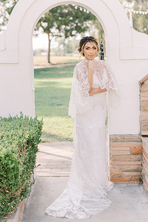  a romantic garden wedding at a Spanish inspired venue with the bride in a lace gown and the groom in a tan suit – bride in her gown 