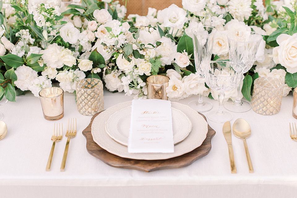 a romantic garden wedding at a Spanish inspired venue with the bride in a lace gown and the groom in a tan suit – dinner flatware