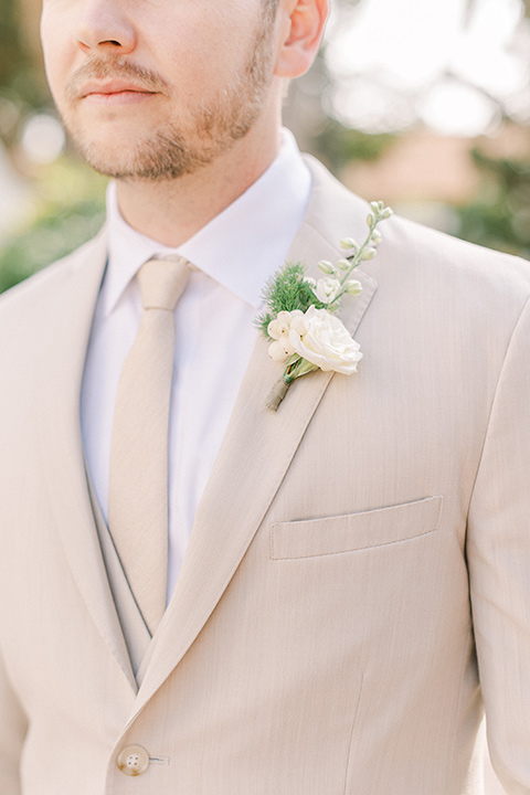  a romantic garden wedding at a Spanish inspired venue with the bride in a lace gown and the groom in a tan suit – groom