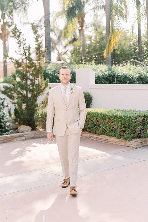  a romantic garden wedding at a Spanish inspired venue with the bride in a lace gown and the groom in a tan suit – groom 