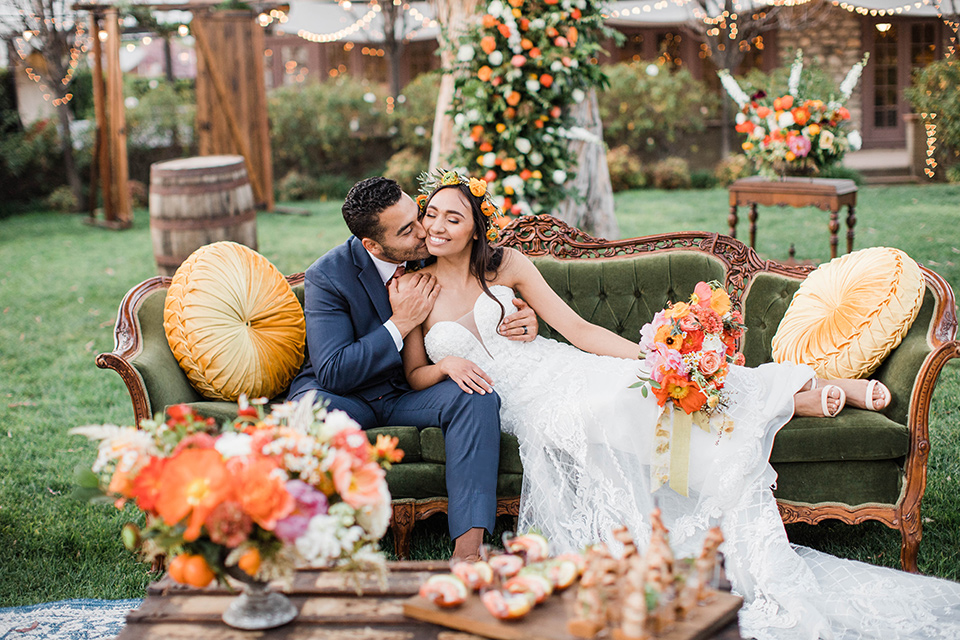  citrus blue and orange wedding with rustic tones – couple sitting on the couch 