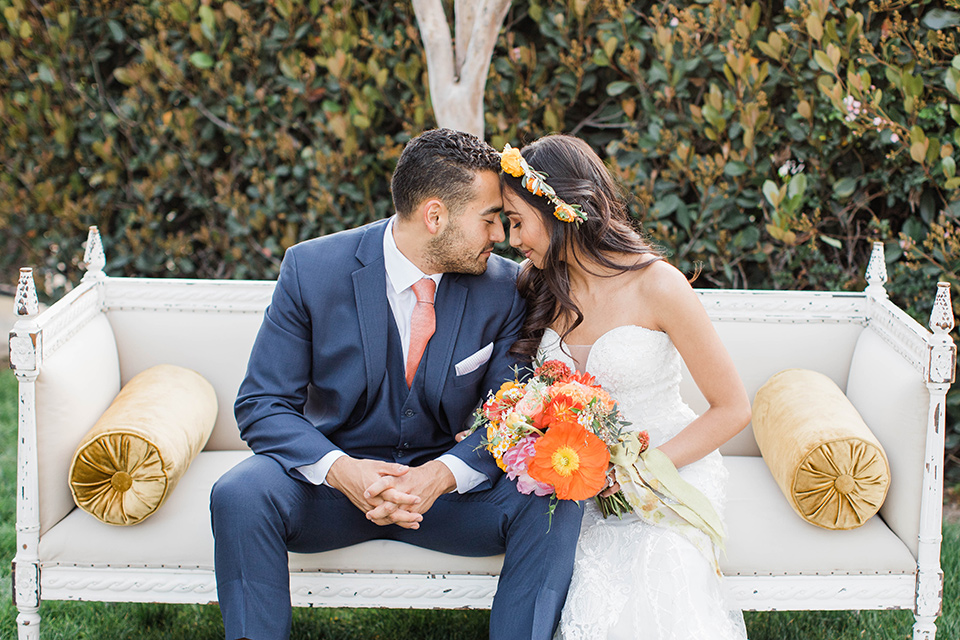  citrus blue and orange wedding with rustic tones – couple sitting on the couch 