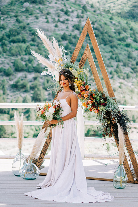  a greenery las vegas wedding at a rustic venue with the bride in an A-line gown and the groom in a green suit – bride