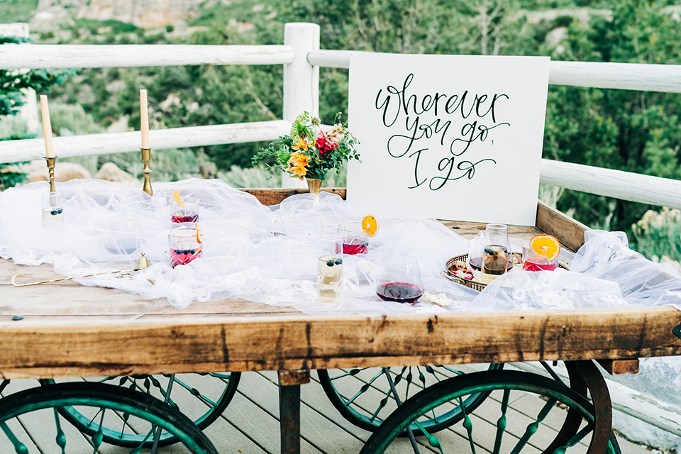  a greenery las vegas wedding at a rustic venue with the bride in an A-line gown and the groom in a green suit – table decor