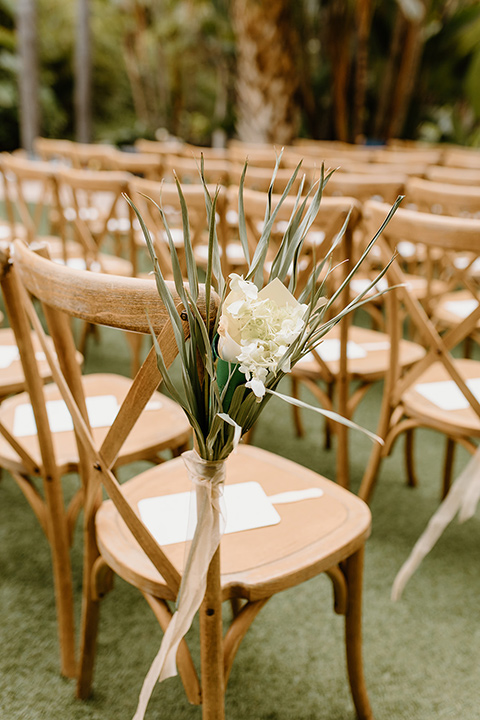  earth-toned boho wedding with the bridesmaids in green dresses, groomsmen in tan suits, and the groom in a caramel suit – chairs 