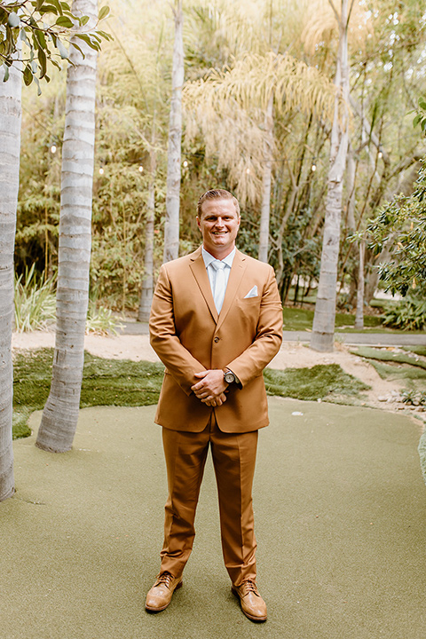  earth-toned boho wedding with the bridesmaids in green dresses, groomsmen in tan suits, and the groom in a caramel suit – groomsmen 