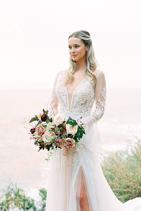  beach side wedding with the bride in a flowing lace gown and the groom in a white tuxedo - bride
