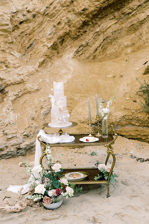  beach side wedding with the bride in a flowing lace gown and the groom in a white tuxedo – cake