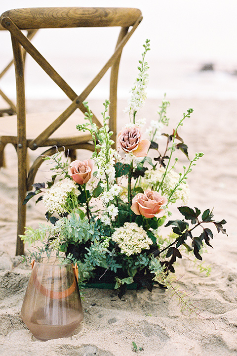  beach side wedding with the bride in a flowing lace gown and the groom in a white tuxedo – chairs