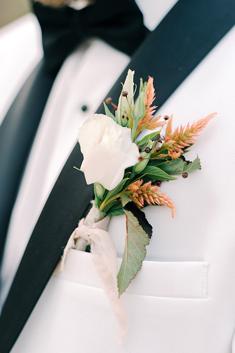  beach side wedding with the bride in a flowing lace gown and the groom in a white tuxedo – groom 