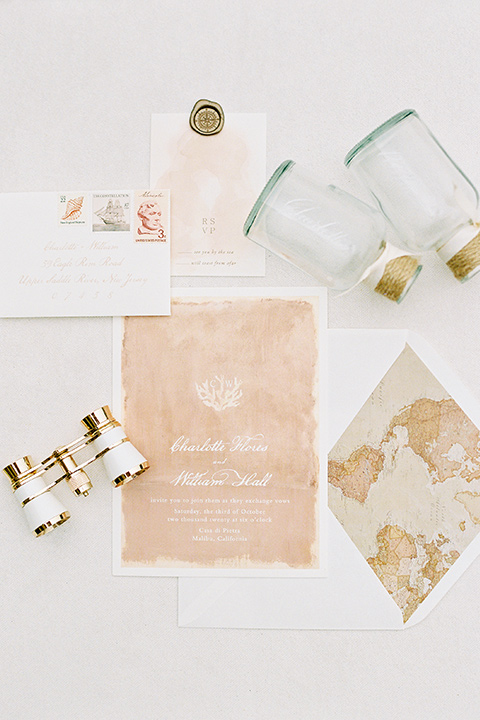  beach side wedding with the bride in a flowing lace gown and the groom in a white tuxedo – invitations