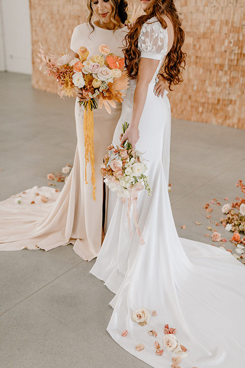  an amber toned wedding in san diego california with the bride in a modern fitted gown with cap sleeves and the groom in a caramel suit – bride and bridesmaid 