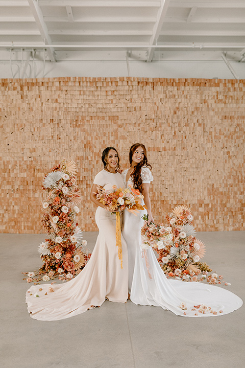  an amber toned wedding in san diego california with the bride in a modern fitted gown with cap sleeves and the groom in a caramel suit – bride and bridesmaid 