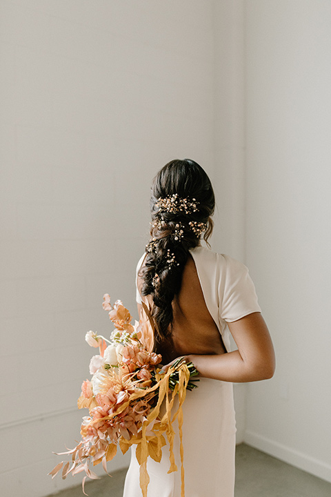  an amber toned wedding in san diego california with the bride in a modern fitted gown with cap sleeves and the groom in a caramel suit – bride in her gown 