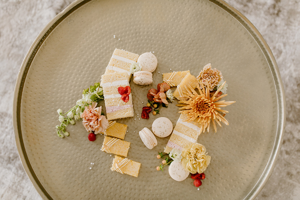  an amber toned wedding in san diego california with the bride in a modern fitted gown with cap sleeves and the groom in a caramel suit – desserts 