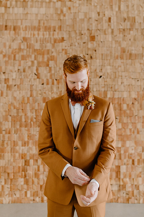  an amber toned wedding in san diego california with the bride in a modern fitted gown with cap sleeves and the groom in a caramel suit – the groom in a caramel suit 