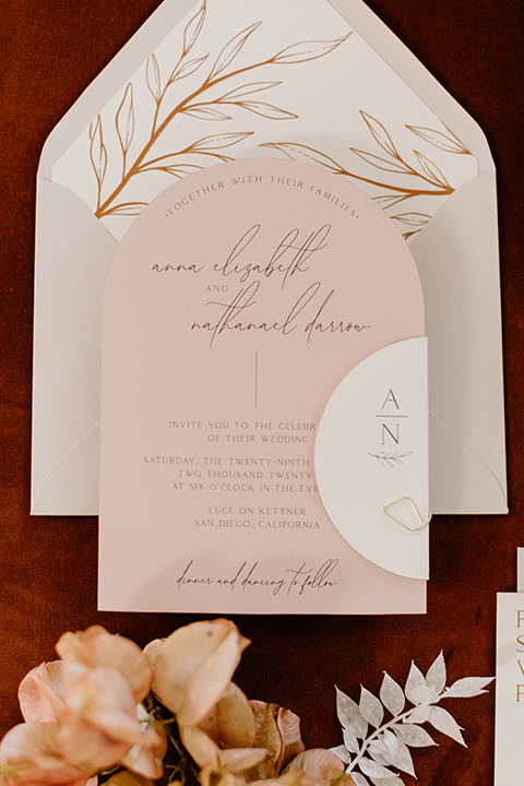 an amber toned wedding in san diego california with the bride in a modern fitted gown with cap sleeves and the groom in a caramel suit – invitations 