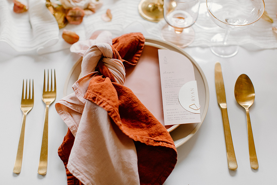  an amber toned wedding in san diego california with the bride in a modern fitted gown with cap sleeves and the groom in a caramel suit – table flatware and decor 
