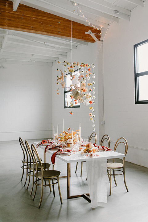  an amber toned wedding in san diego california with the bride in a modern fitted gown with cap sleeves and the groom in a caramel suit – the reception tables and décor 