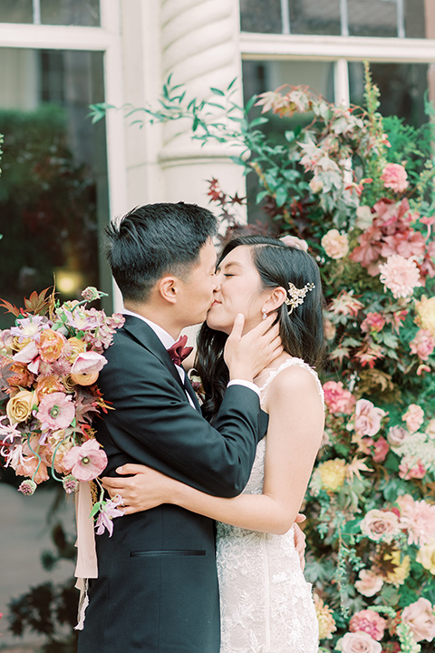  black and white wedding design at the Maxwell House with touches of pink – ceremony close up and kissing 