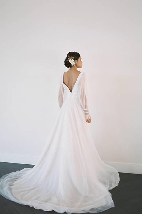  minimalistic nude wedding with vintage touches, the bride in a flowing gown with sleeves and the groom in a tan suit - bride 