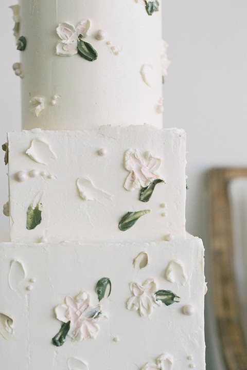  minimalistic nude wedding with vintage touches, the bride in a flowing gown with sleeves and the groom in a tan suit - cake