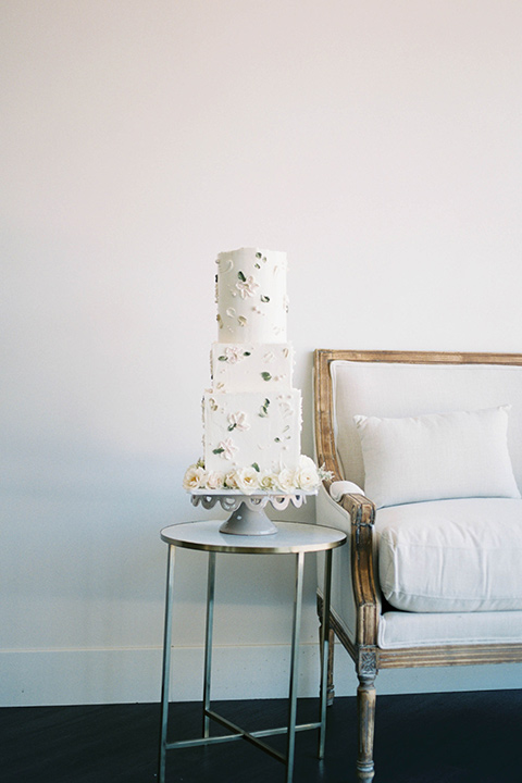  minimalistic nude wedding with vintage touches, the bride in a flowing gown with sleeves and the groom in a tan suit - cake 