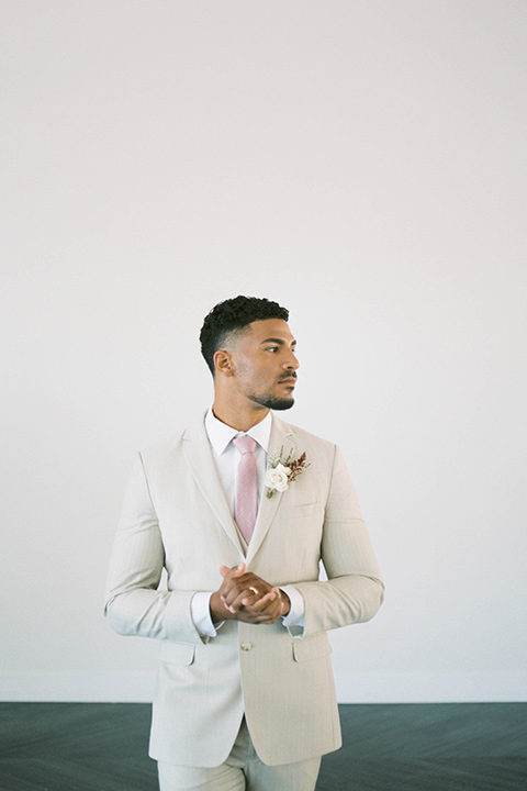  minimalistic nude wedding with vintage touches, the bride in a flowing gown with sleeves and the groom in a tan suit – groom 