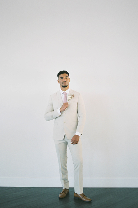  minimalistic nude wedding with vintage touches, the bride in a flowing gown with sleeves and the groom in a tan suit – groom 