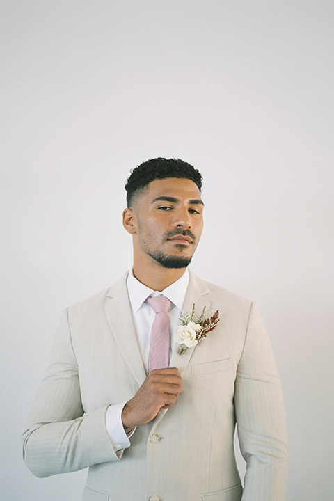  minimalistic nude wedding with vintage touches, the bride in a flowing gown with sleeves and the groom in a tan suit – groom 