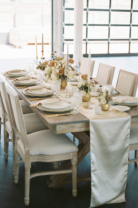 minimalistic nude wedding with vintage touches, the bride in a flowing gown with sleeves and the groom in a tan suit – table 