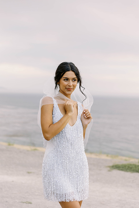  modern black and white upscale wedding on the cliffs overlooking the ocean – bride in short gown 