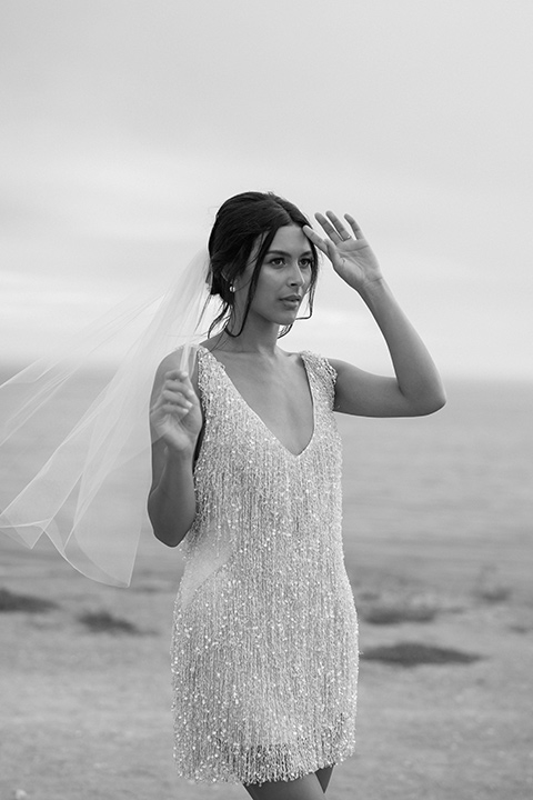  modern black and white upscale wedding on the cliffs overlooking the ocean – bride in short gown 