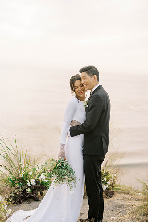  modern black and white upscale wedding on the cliffs overlooking the ocean – couple at ceremony 