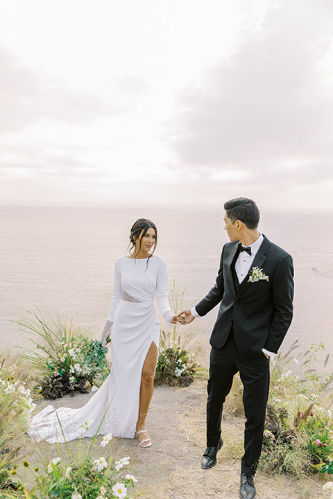  modern black and white upscale wedding on the cliffs overlooking the ocean –  couple at ceremony 