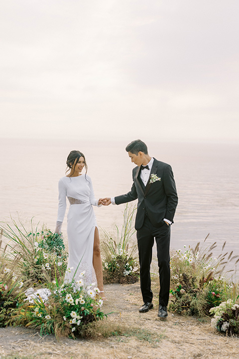  modern black and white upscale wedding on the cliffs overlooking the ocean – couple at ceremony 