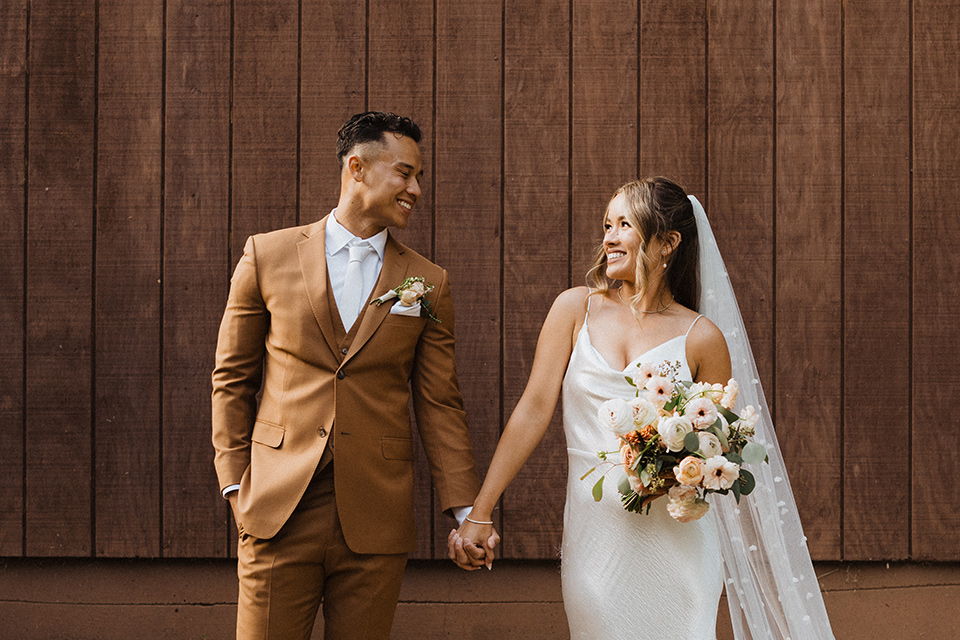  a neutral monochromatic earth toned wedding with boho trendy vibes - couple looking at each other 
